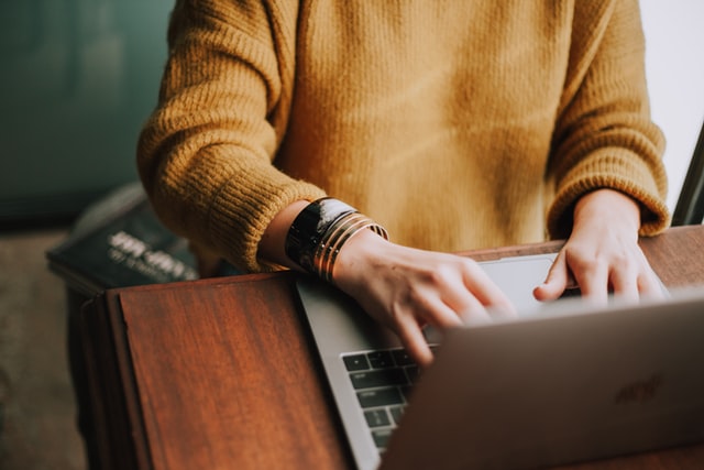Image of a woman typing at desk