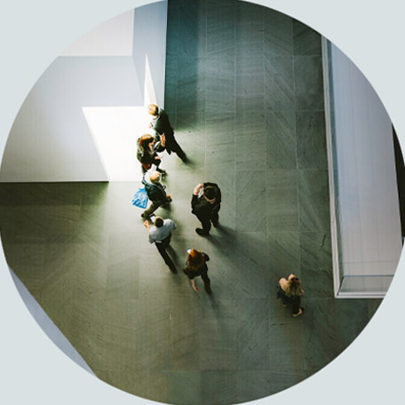 People moving through the bright atrium of a modern workplace