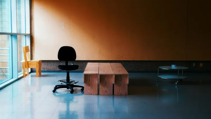 Empty office with a desk chair and bench, AWA Guide to Office Relocation