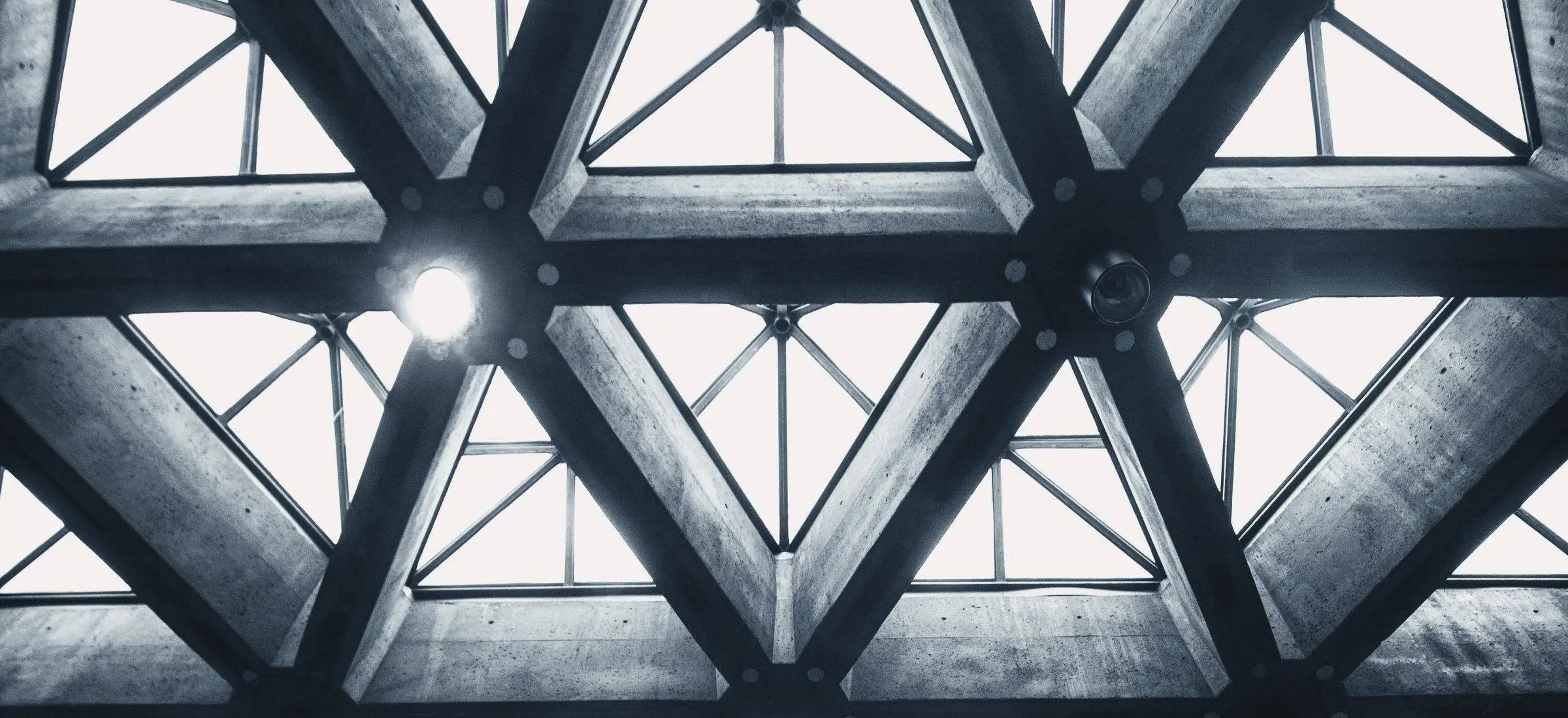 Triangular glass roof of an office atrium, illustrating long-term office lease decisions