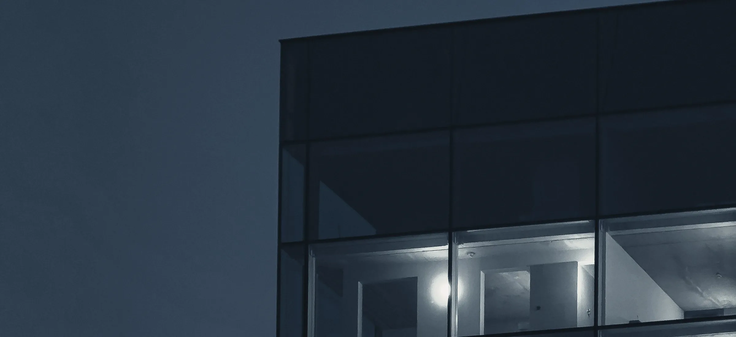Office building at dusk with lit windows, illustrating the countdown to an office lease expiry